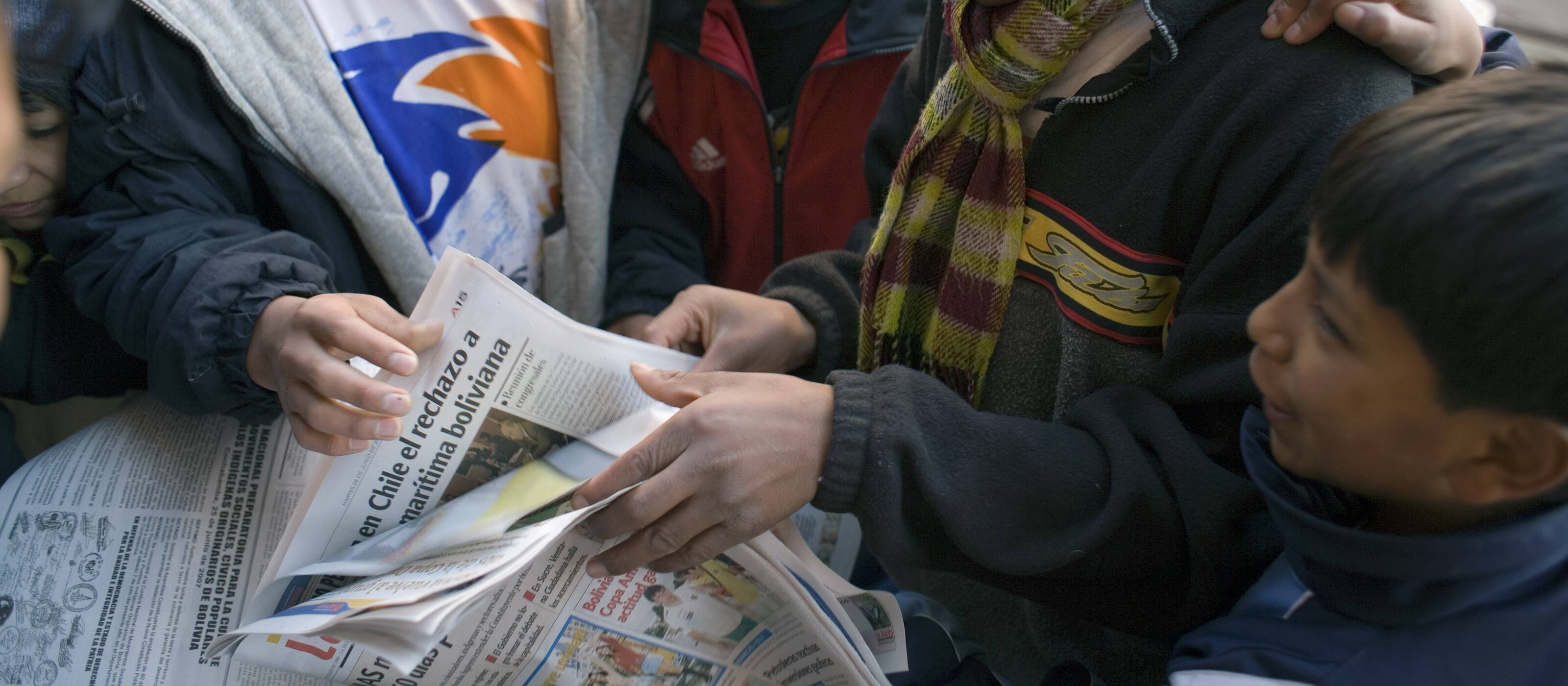 Young people get information in the newspaper 