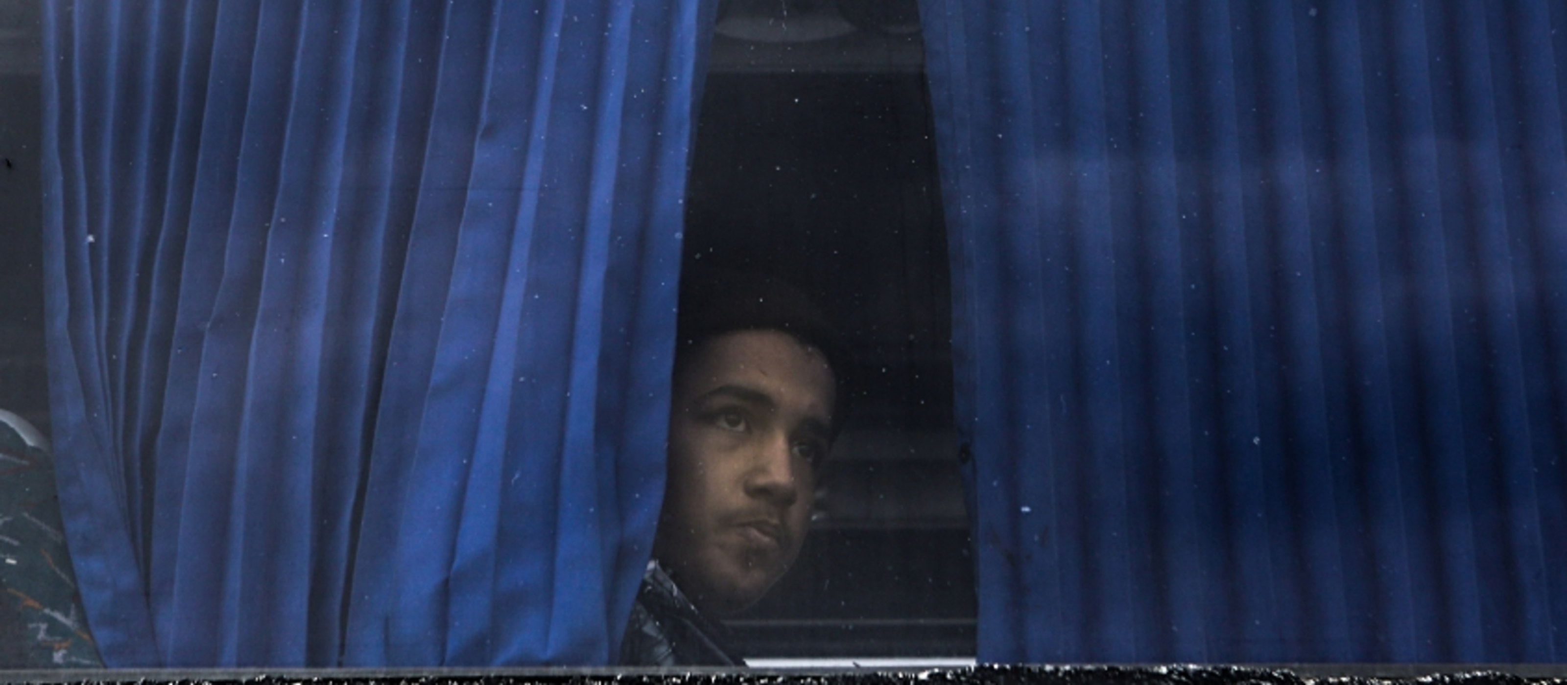Symbolic image of a migrant on a bus.