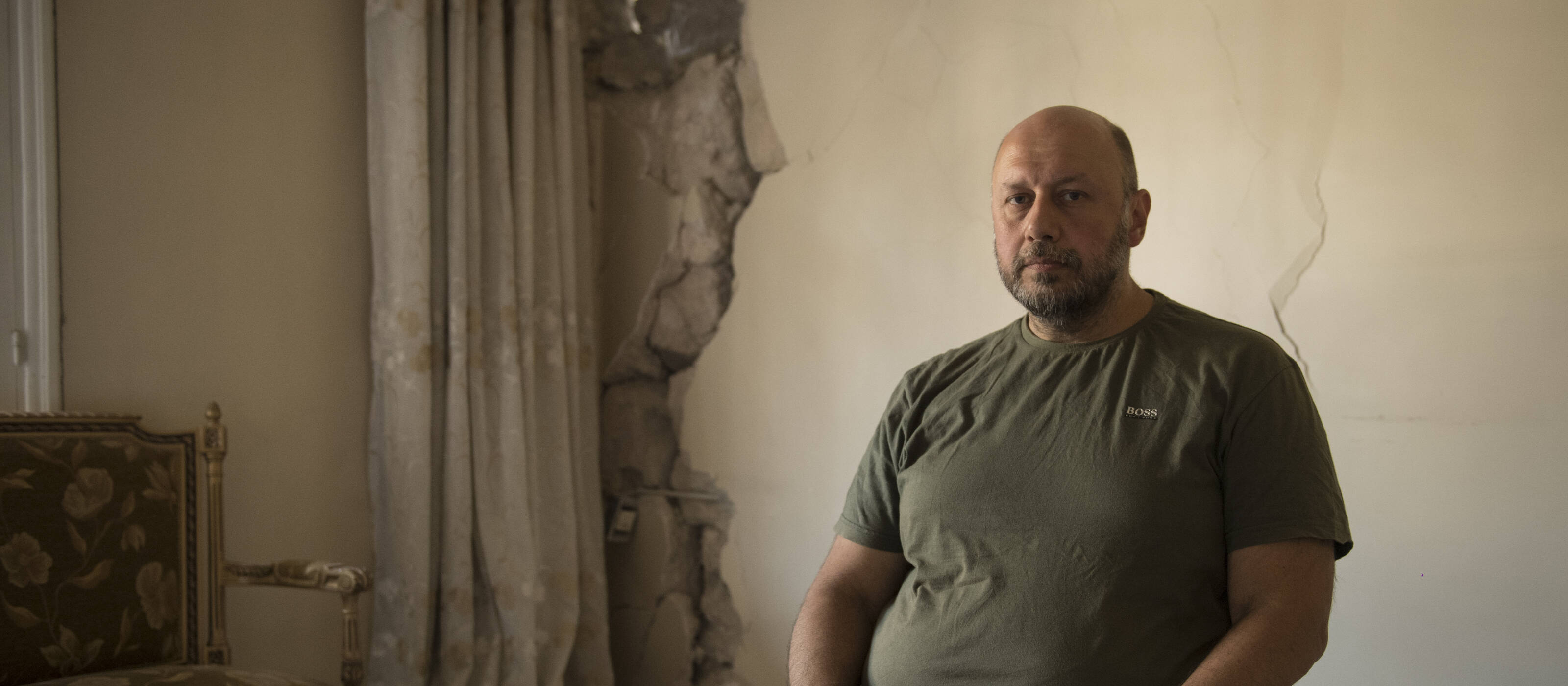 George S. in his apartment in Aleppo, which is uninhabitable because of the earthquake.